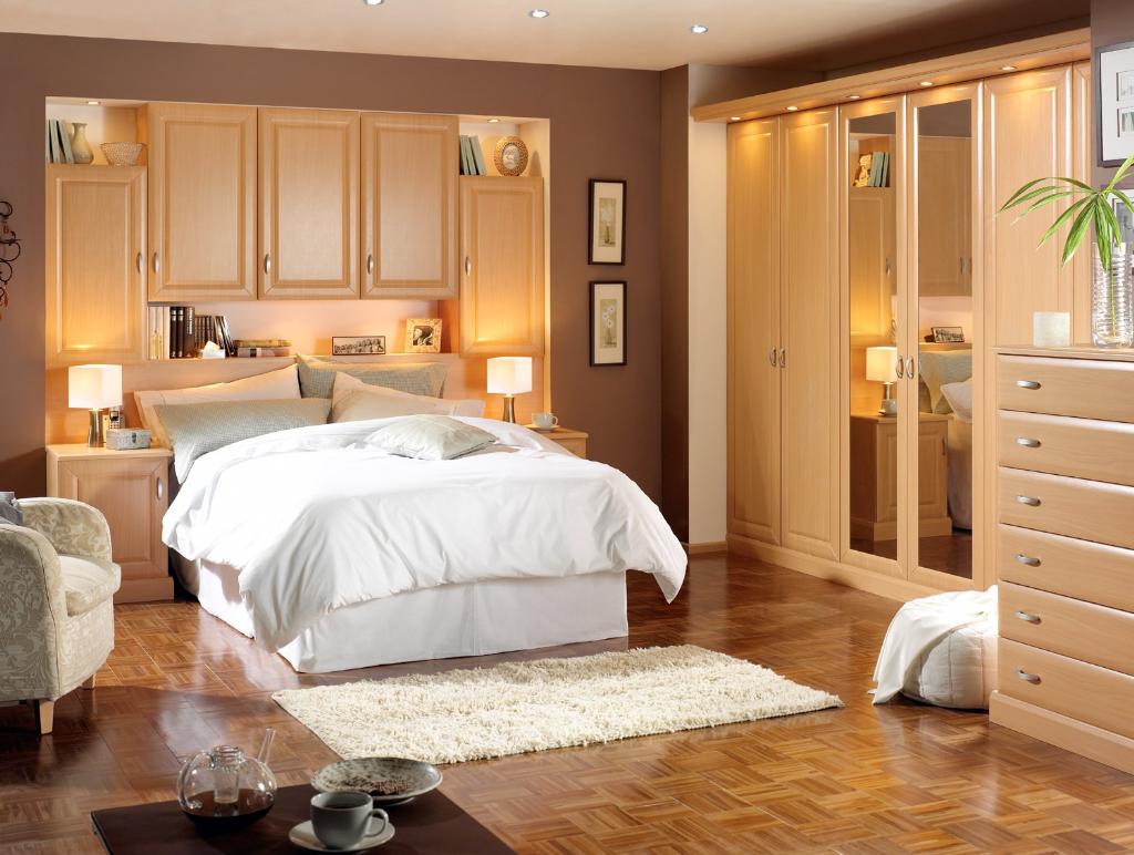 beige-bedroom-design-featuring-delectable-wood-closet-furniture-units-with-mirror-also-completed-with-bed-cabinets-storager-over-white-bedsheets-paired-with-sofa-units